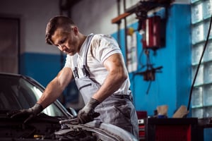 Image of professional uniformed car mechanic working in service station